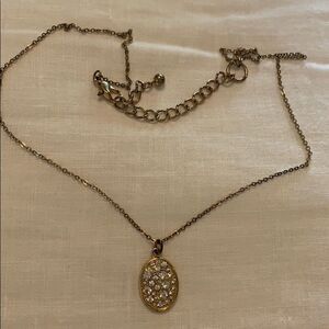 Gold necklace with a gold/diamond pendant